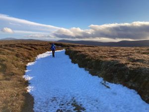 Justine walking in a wintery day on the Cairngorms